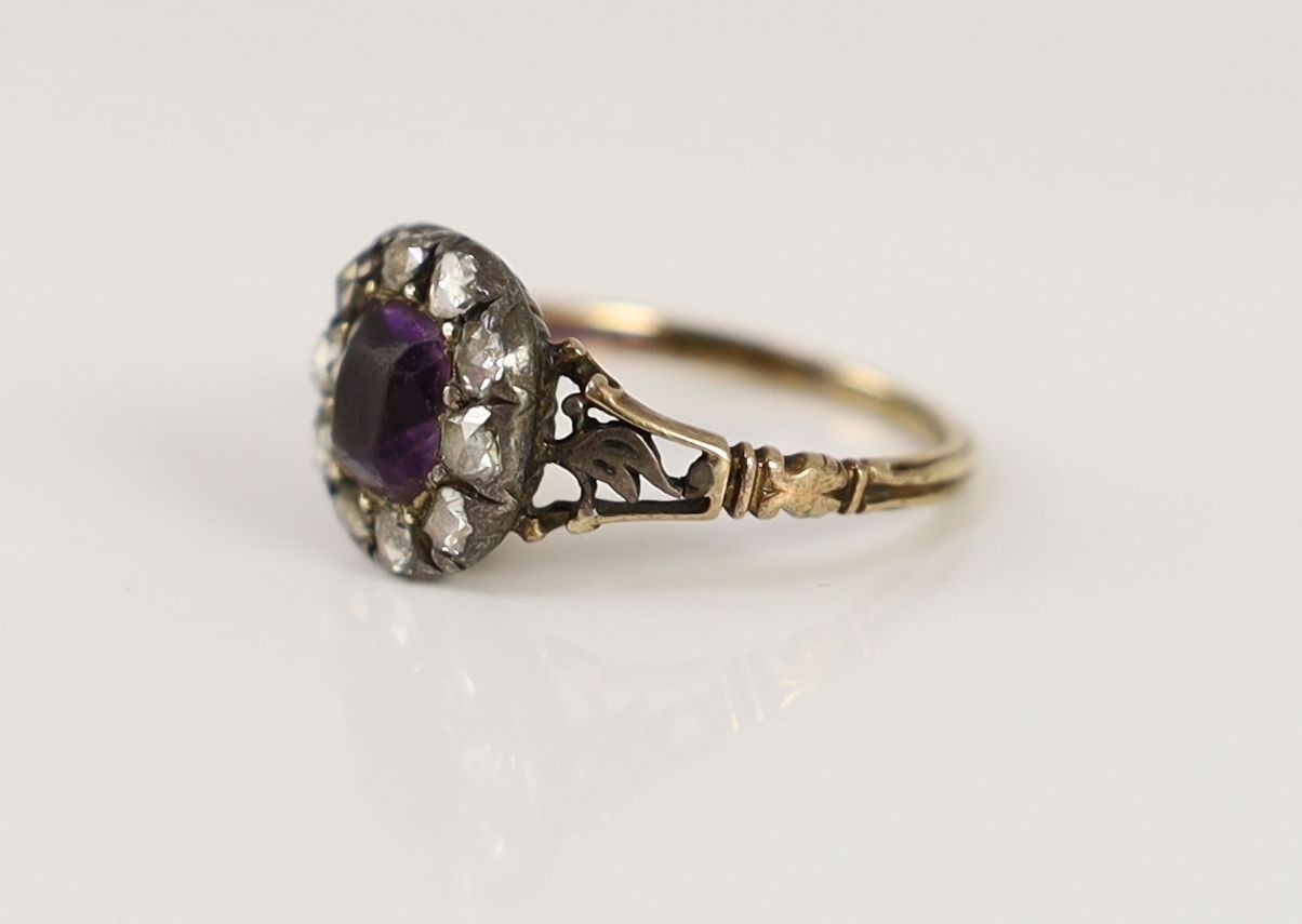 A Georgian gold, foil backed amethyst and rose cut diamond set cluster ring